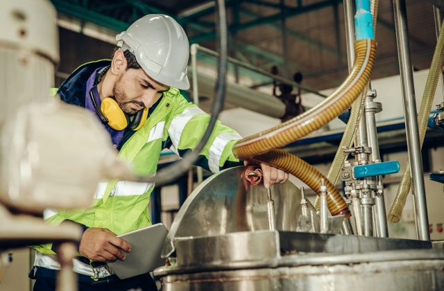 Factory worker engineer staff working in dangerous environment concept, checking chemical boiler